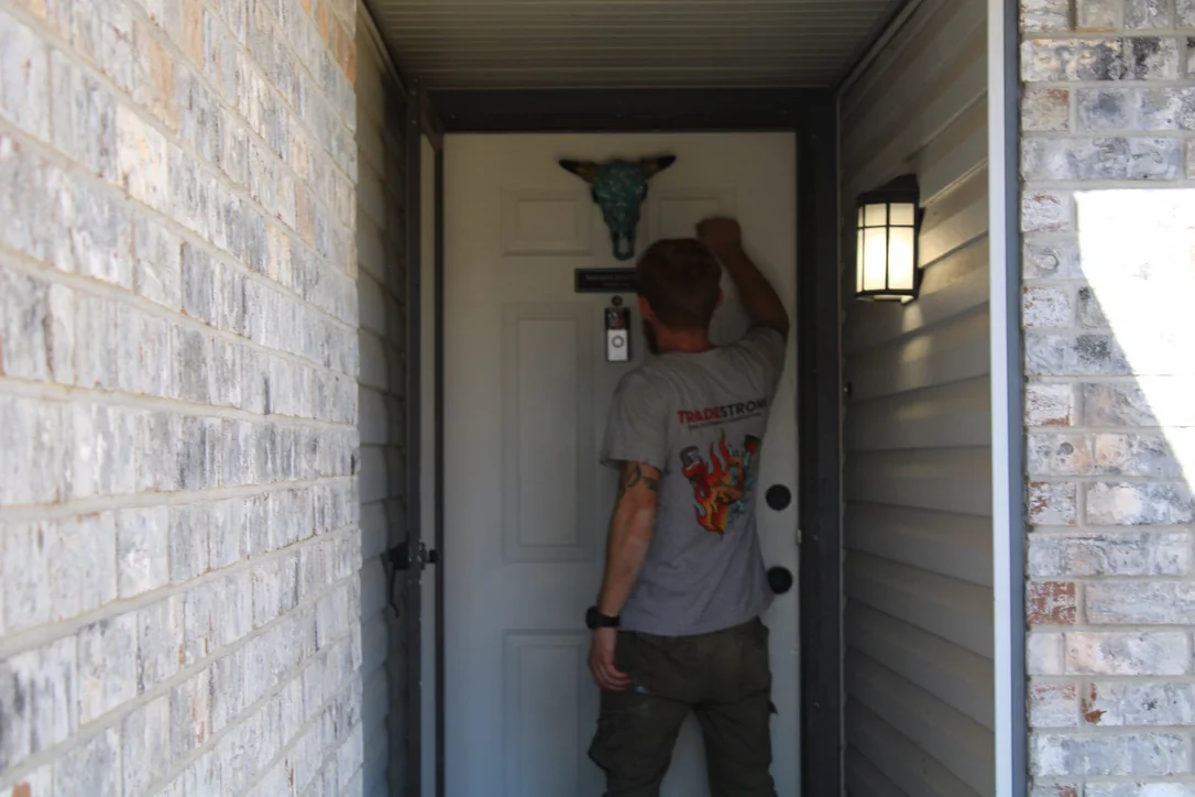 TradeStrong technician helping a homeowner prepare an HVAC or plumbing quote