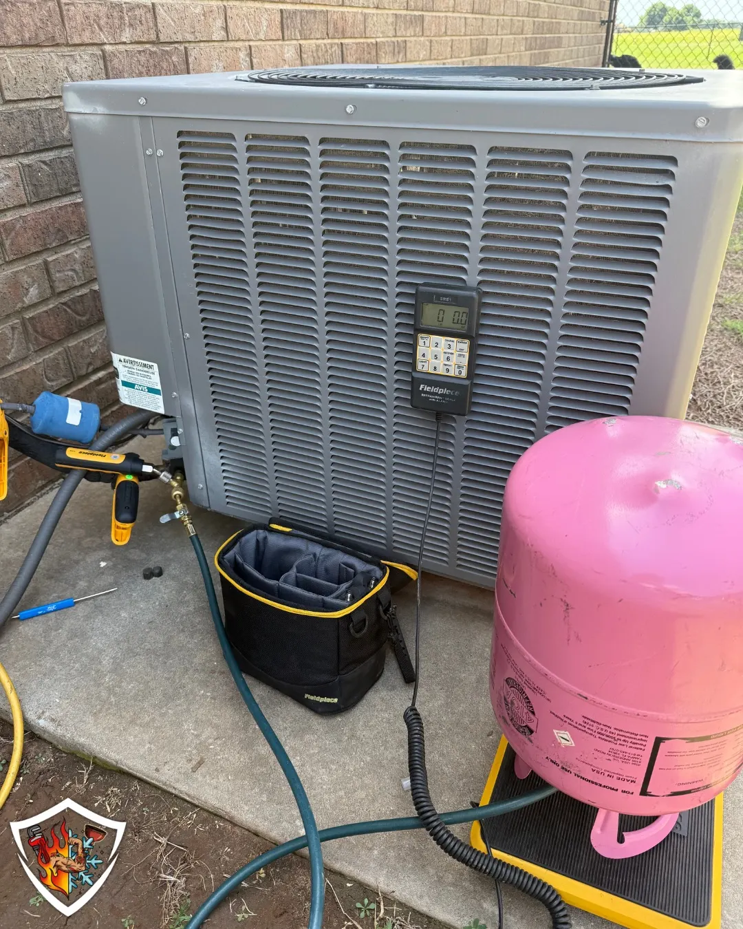 TradeStrong charging R410A refrigerant on an air conditioner in Newcastle