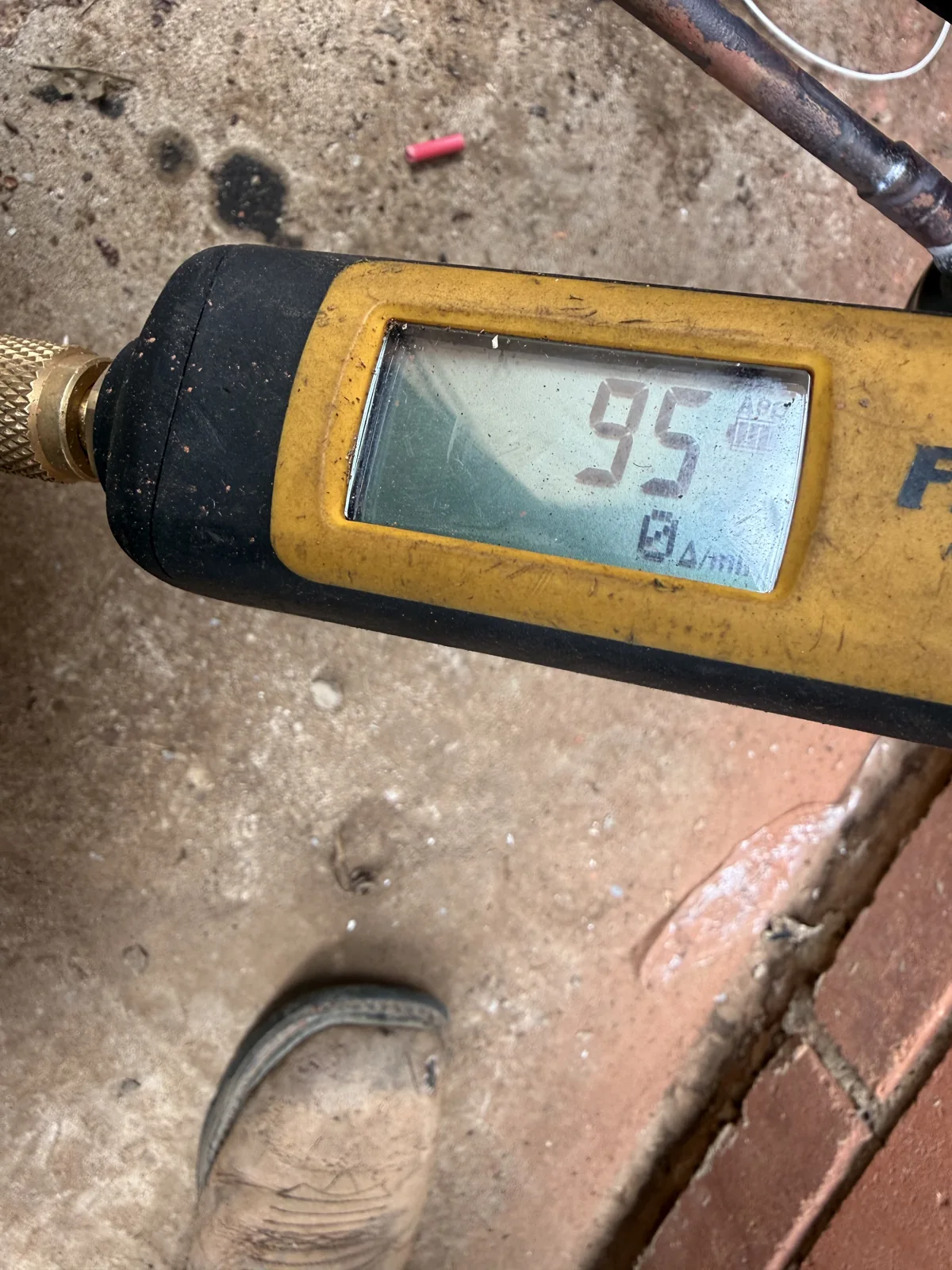 Digital vacuum gauge showing 95 and a zero rate-of-change reading during the Edmond installation