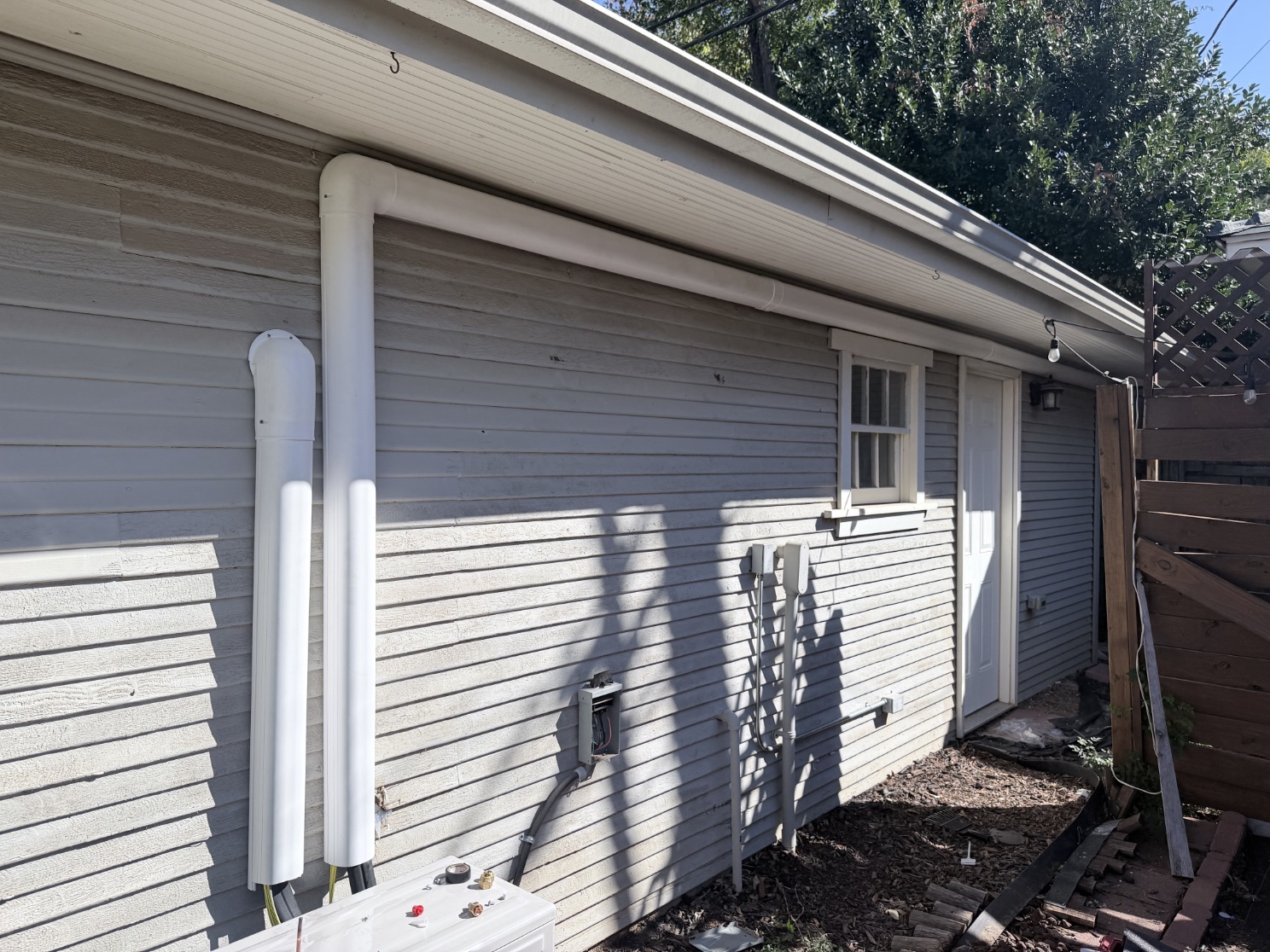 White mini-split line-set covers following the siding and eave of an older Heritage Hills Oklahoma City property