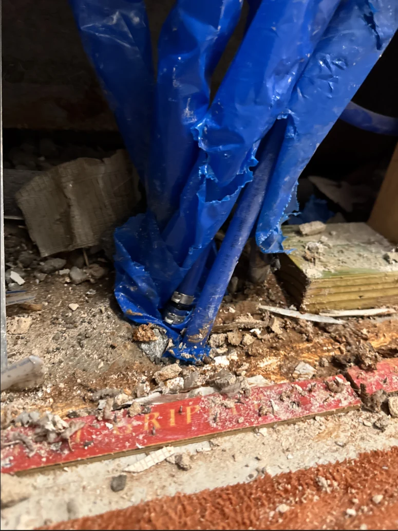 Repaired water line positioned just above the concrete floor inside a Yukon Oklahoma wall