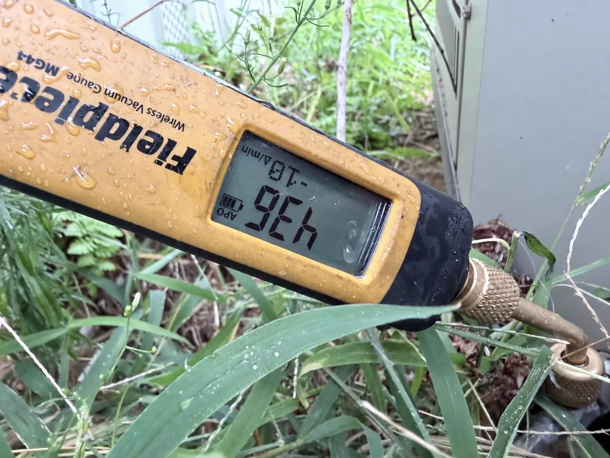 Fieldpiece vacuum gauge connected at the outdoor condenser during evacuation