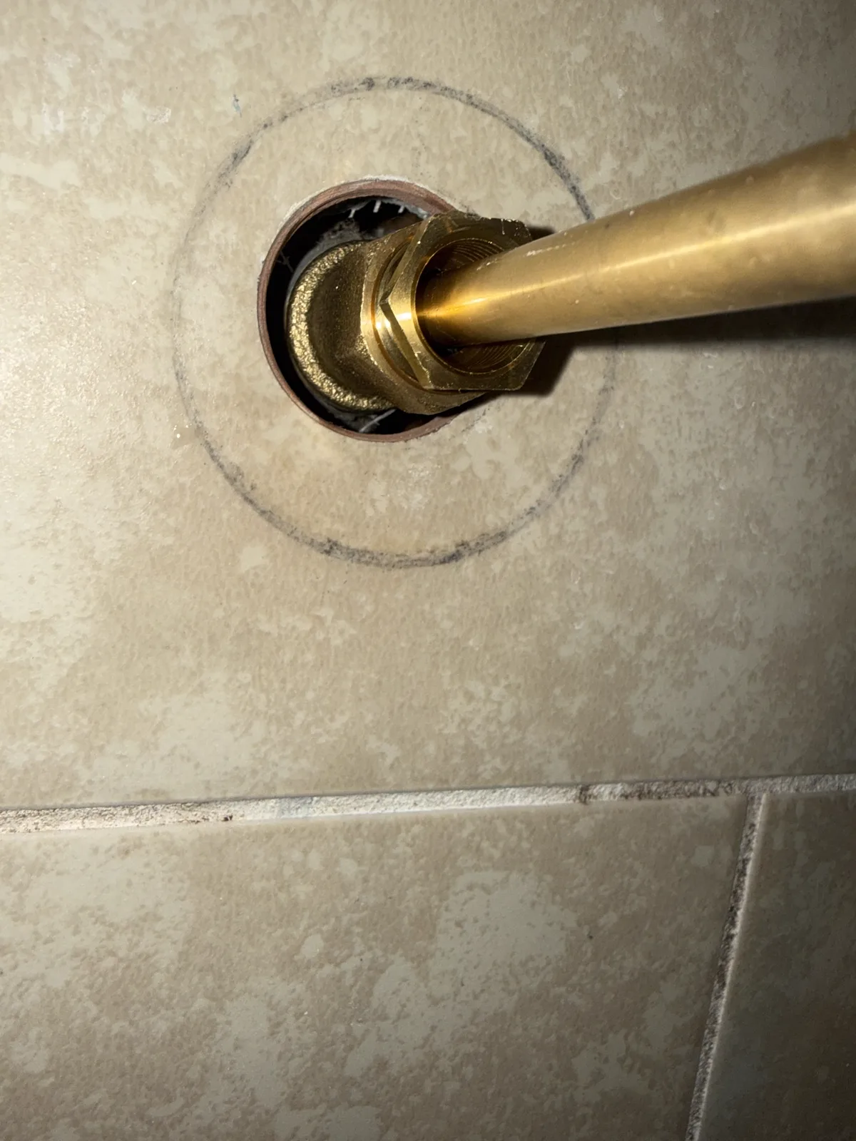 Close-up of an older shower valve with the handle trim removed during plumbing service in Southwest Oklahoma City