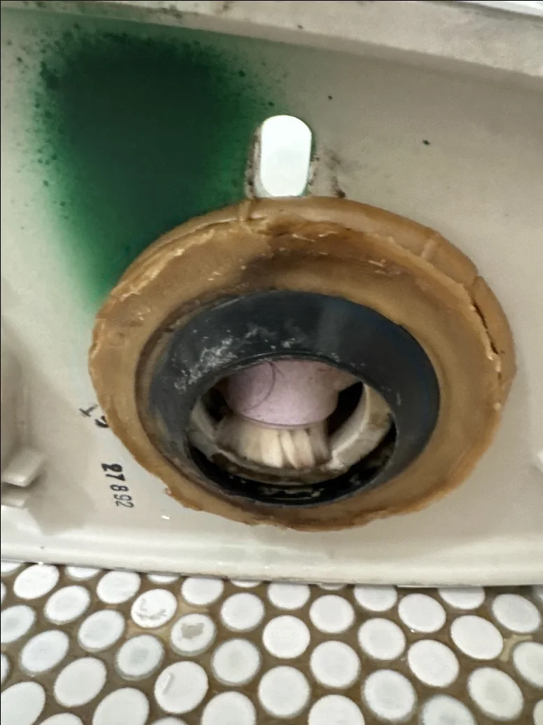 Brush lodged inside a toilet trap after the toilet was removed in Edmond Oklahoma